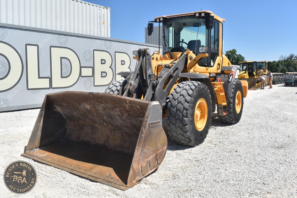 Yellow wheel loader with large bucket at Bussey Bros Auctioneers yard.