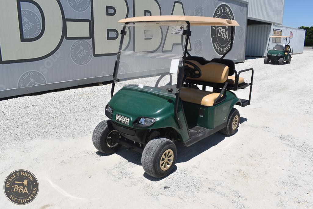 Green golf cart with beige seats at Bussey Bros Auctioneers.