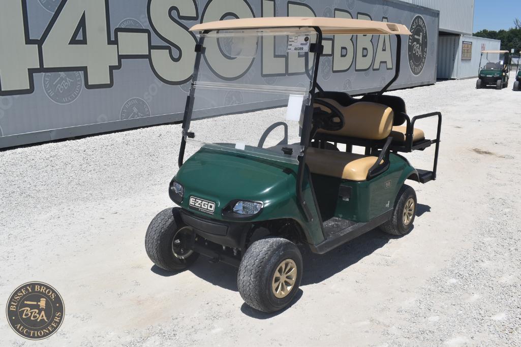 Golf cart with beige seats and green body, ideal for recreational use or transportation on golf cour.