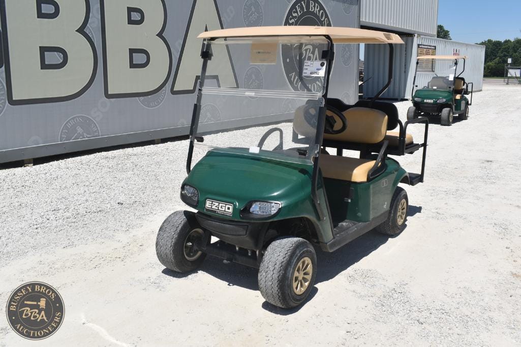 Golf cart with beige seats and a green body, ideal for golf courses or transportation needs.