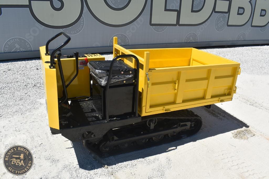 Mobile tracked dump trailer for construction and industrial use.