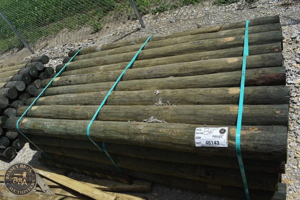 Wooden logs for sale at Bussey Bros Auctioneers, ideal for construction or firewood.