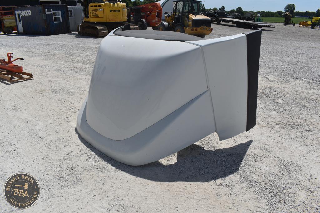 Excavator bucket attachment displayed outdoors at Bussey Bros Auctioneers.