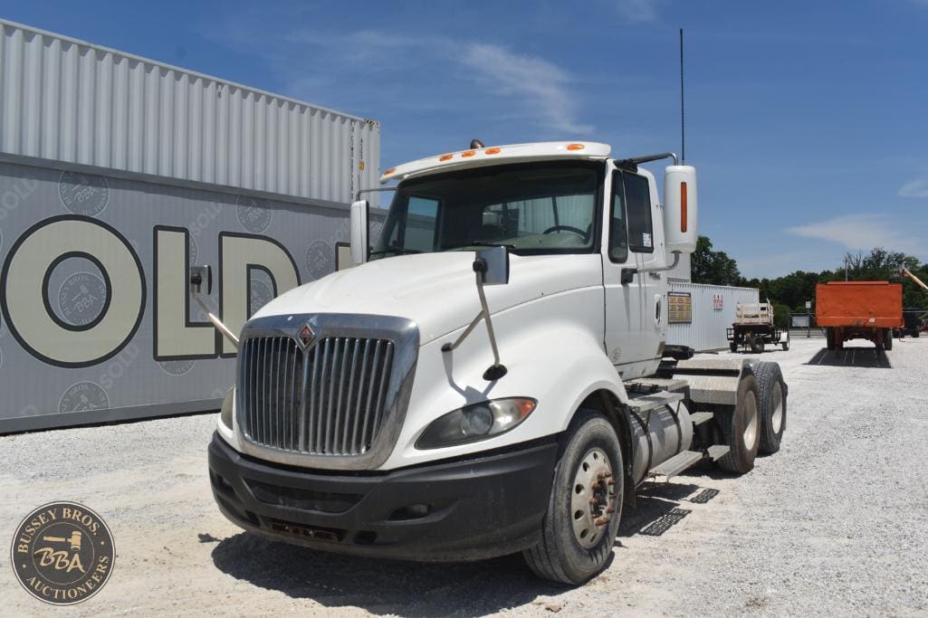 White commercial truck parked at Bussey Bros Auctioneers yard, ready for auction.
