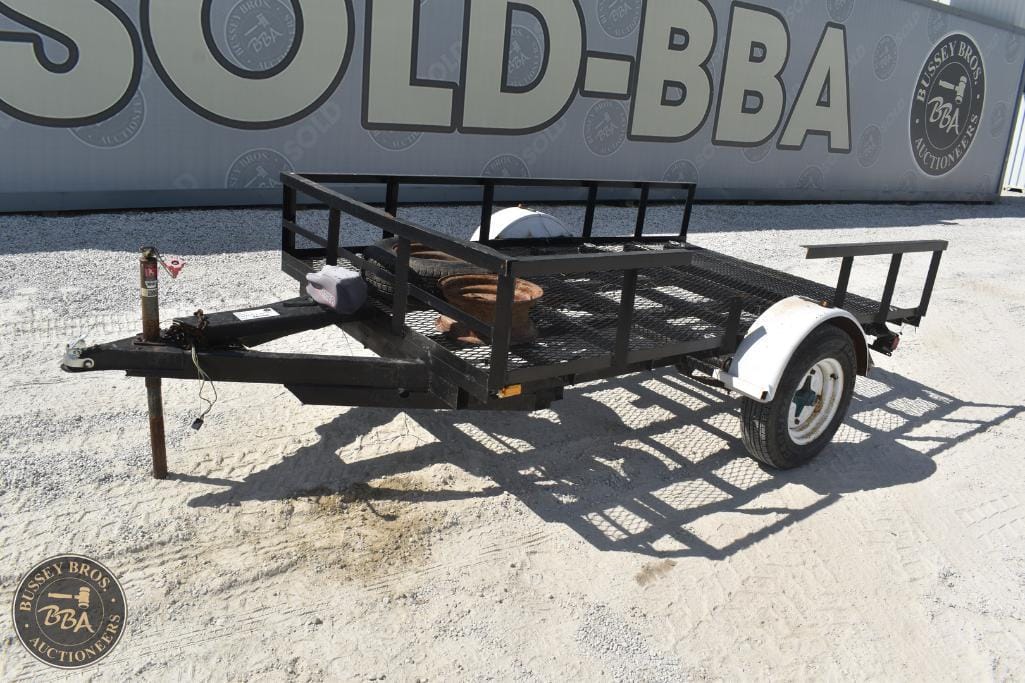 Portable utility trailer with metal frame and single axle.