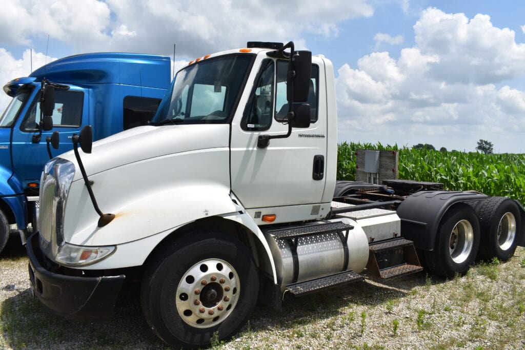 White and black semi-truck at Bussey Bros Auctioneers.