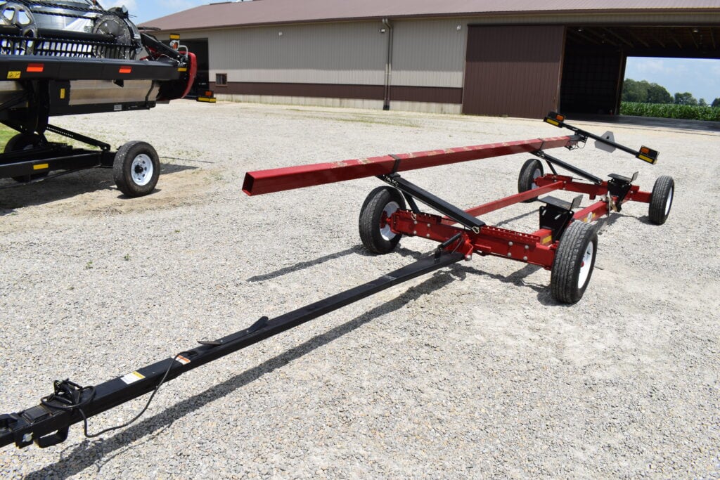 Red farm equipment trailer at HANSBARGER FARM RETIREMENT AUCTION.