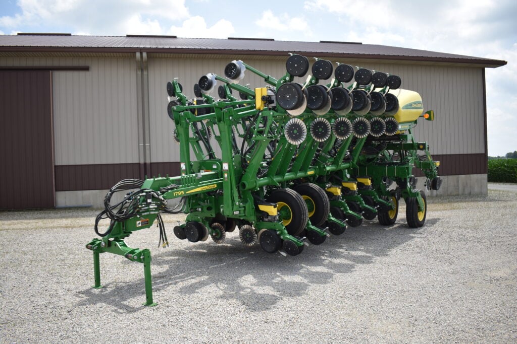 Green agricultural planter equipment at Bussey Bros Auction.