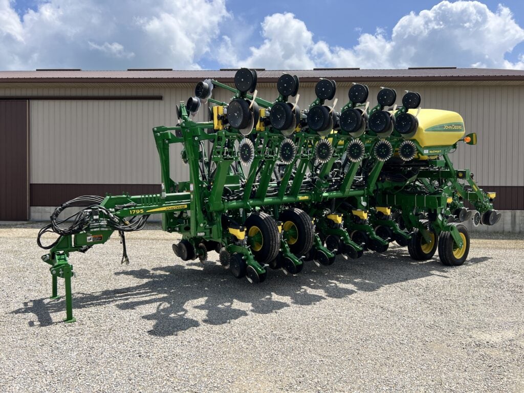 Green and yellow farm machinery at Bussey Bros Auction site.