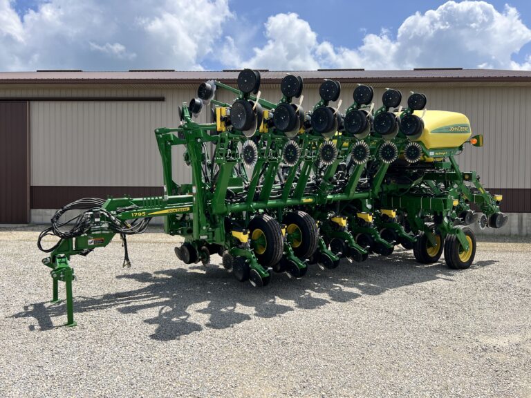 Green and yellow farm machinery at Bussey Bros Auction site.