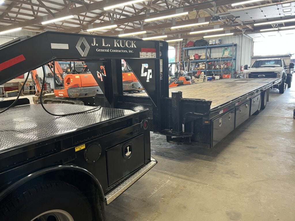 Flatbed truck from J.L. Kuck auction in indoor warehouse setting.
