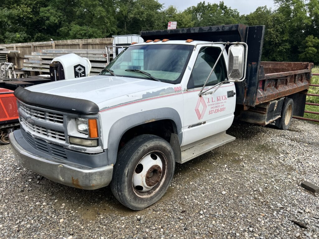 White dump truck with black bed at Bussey Bros Auction.