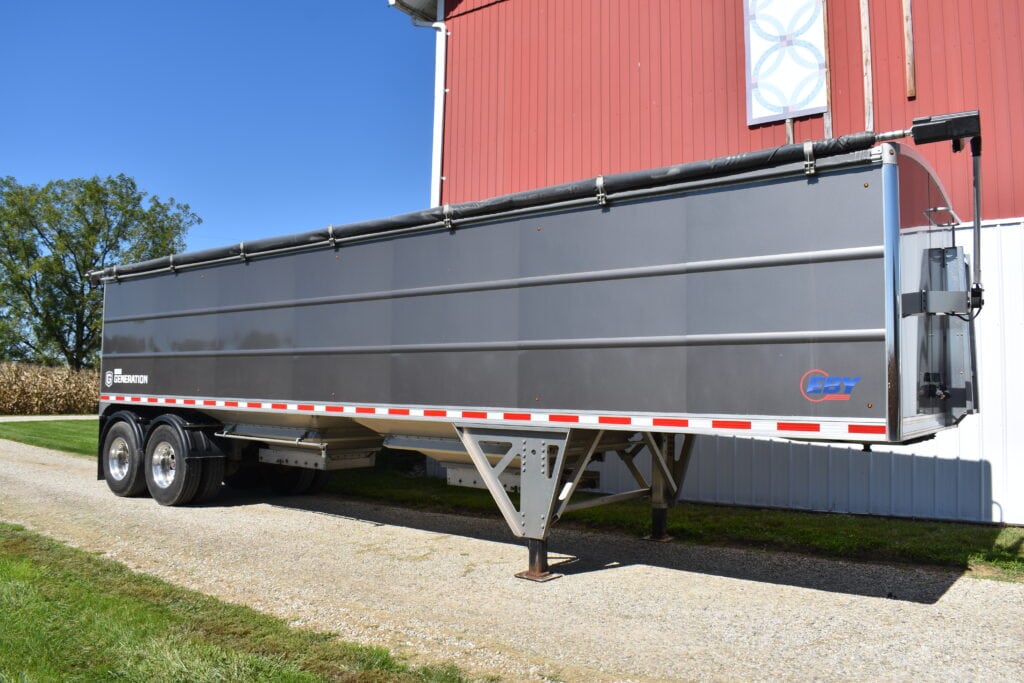Gray grain trailer parked outside at Stebbins Farm Retirement Auction.