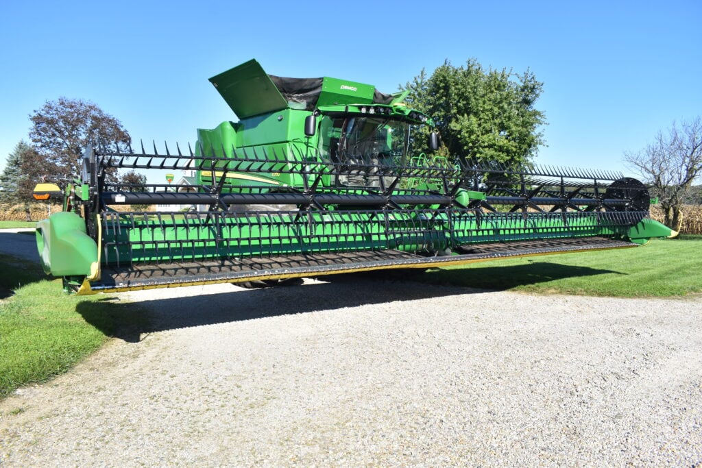 Green John Deere combine harvester at Stebbins Farm Retirement Auction.