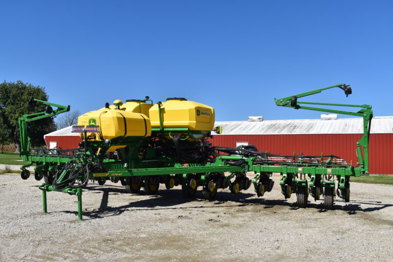 Large green and yellow farm sprayer equipment at Stebbins Farm Auction.