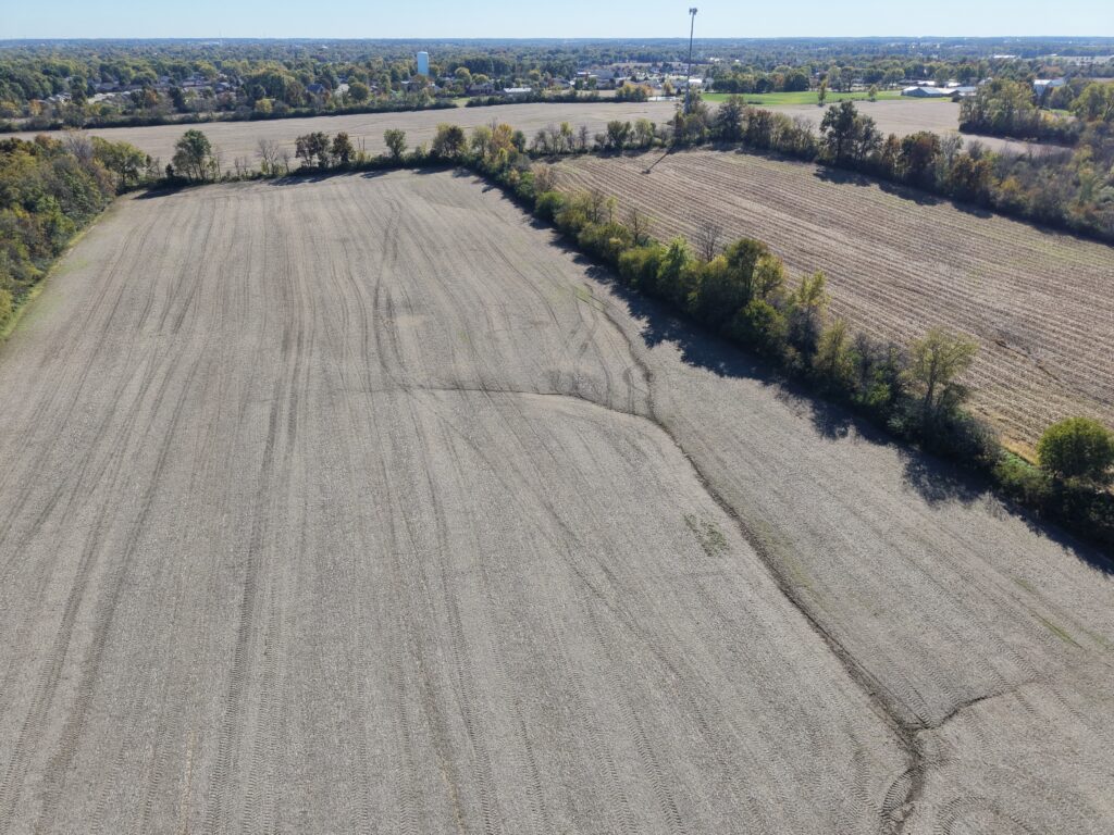 Aerial view of farmland with fields and tree lines near Stanforth estate auction.