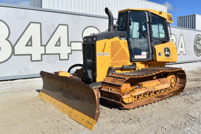 Yellow John Deere bulldozer with blade attachment on gravel surface.
