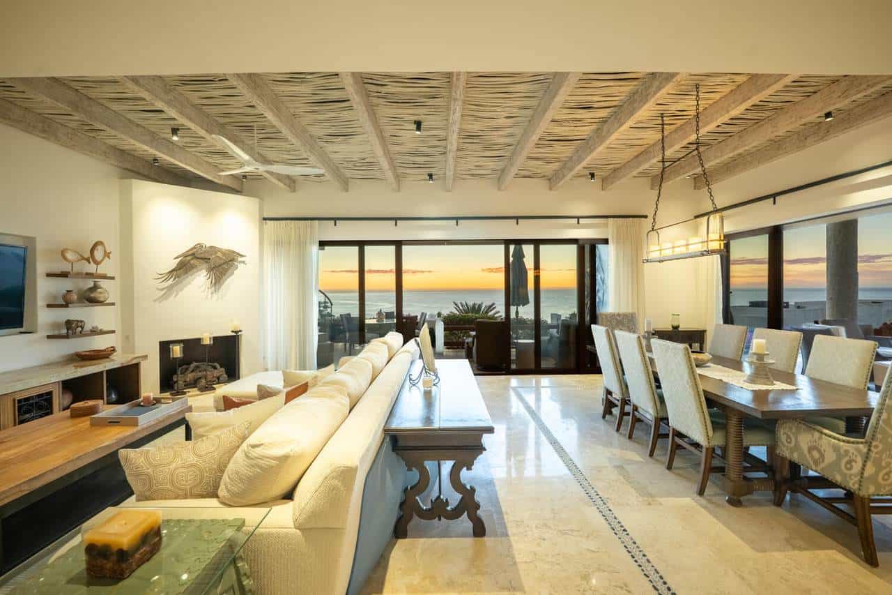Luxurious Cabo Real Ocean-View Living Room With Natural Wood Ceiling, Elegant Furniture, And Sunset Views, Perfect For Relaxing In Cabo Real Real Estate Properties.