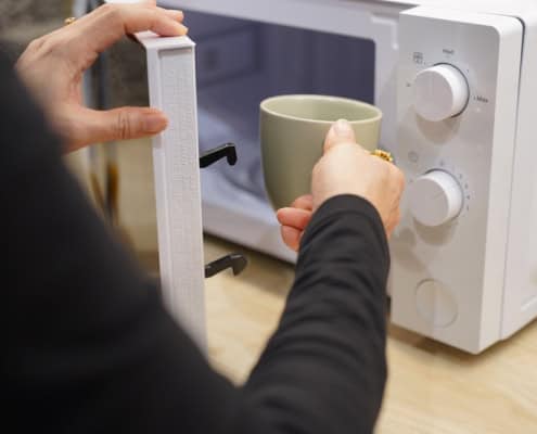 Freshly brewed coffee being prepared in a microwave at Café Tolento.
