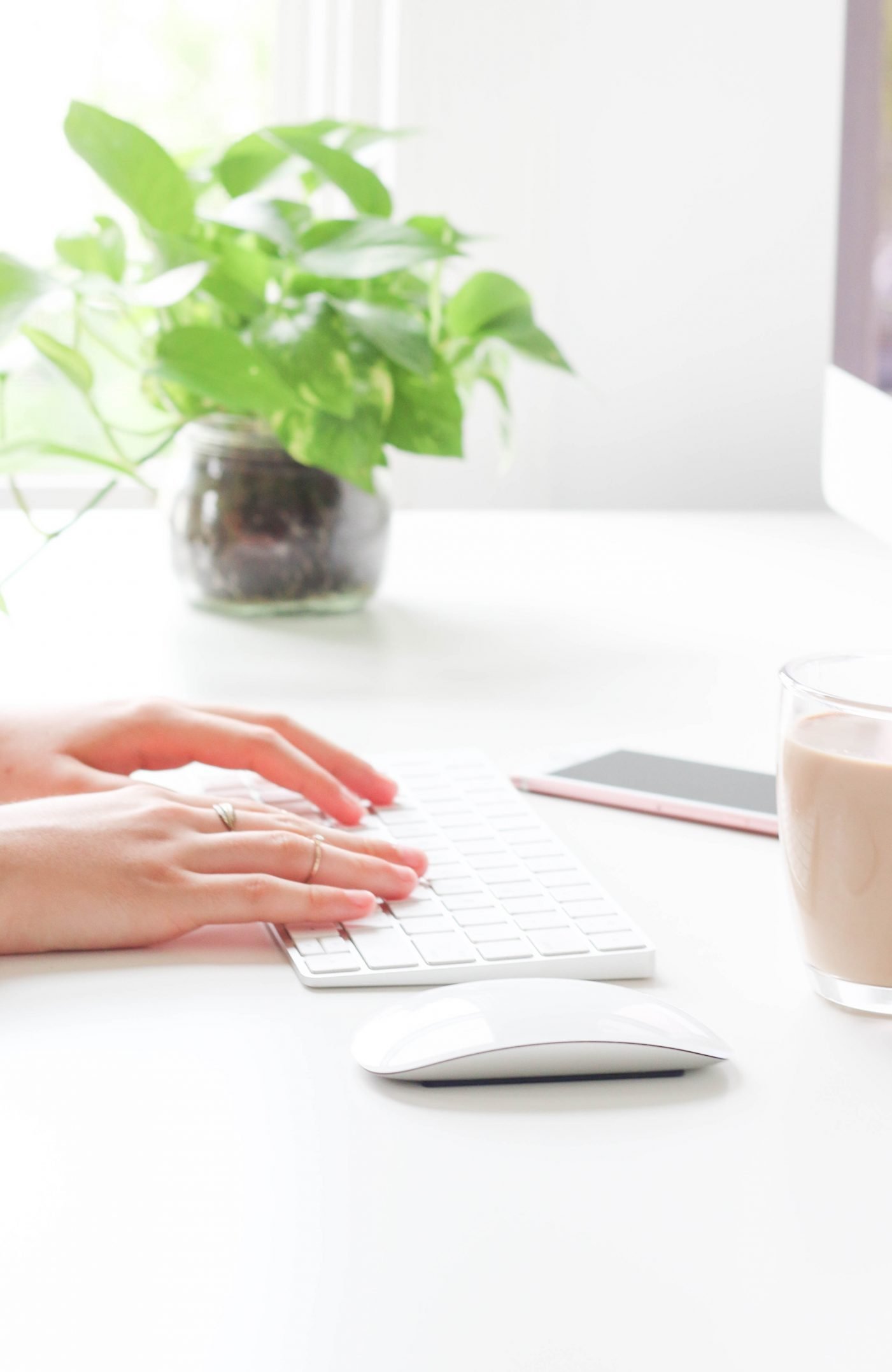 A photograph of a woman typing