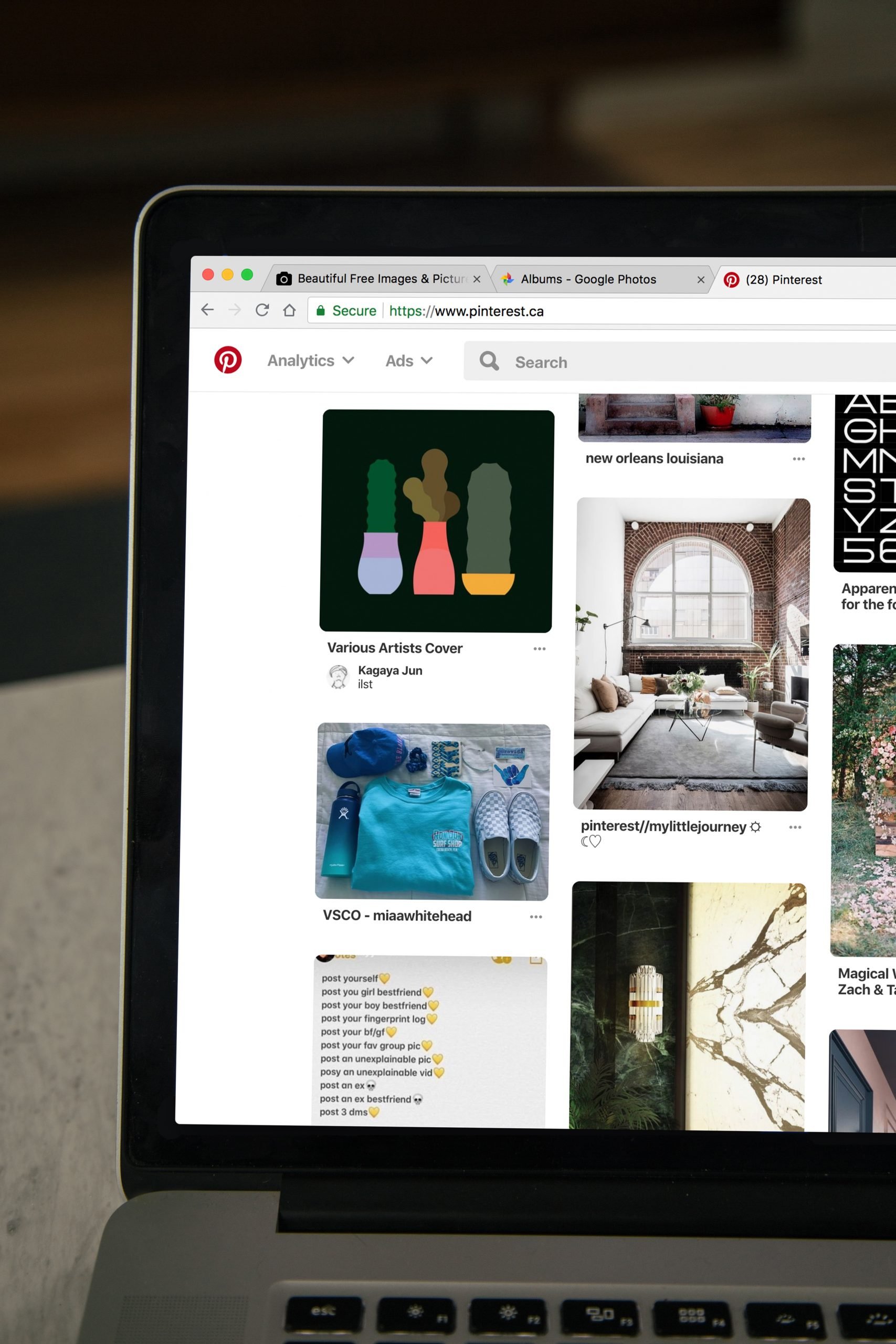 A photograph of a laptop with Pinterest open on the screen