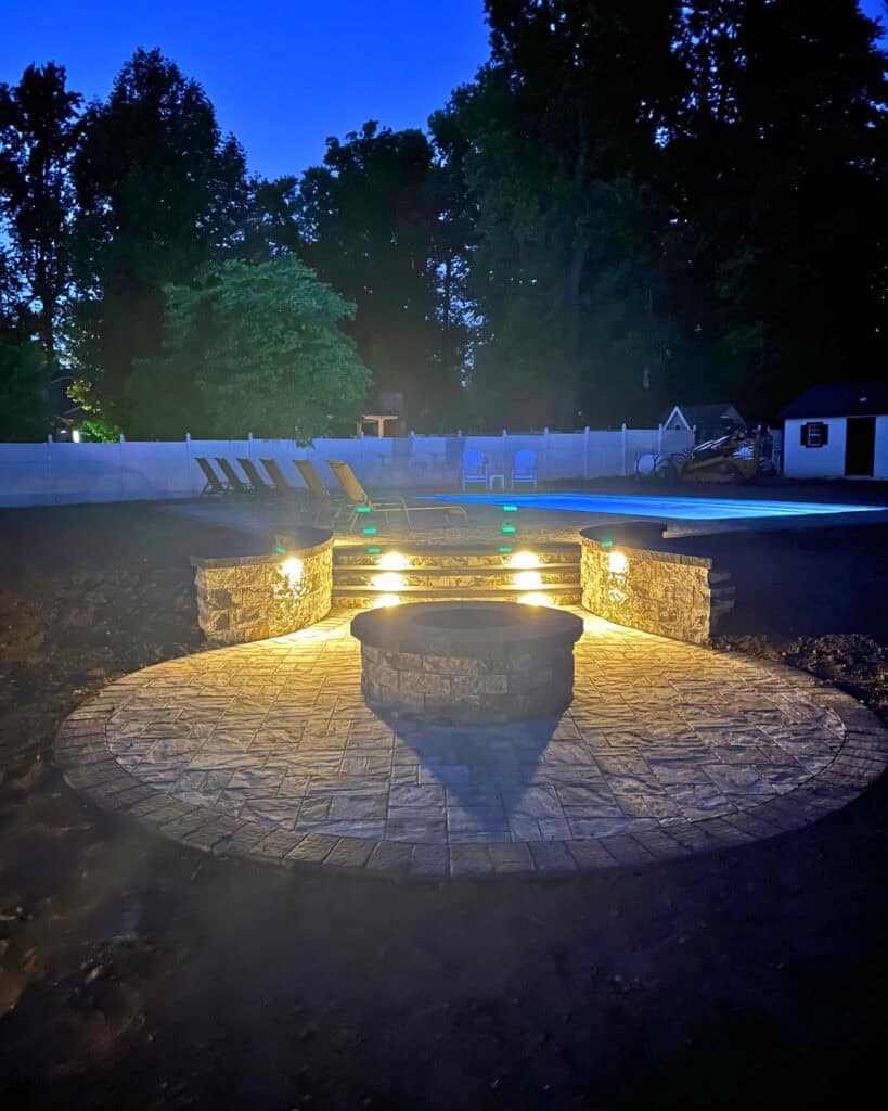 Outdoor fire pit with stone surround and LED lighting for cozy evenings.
