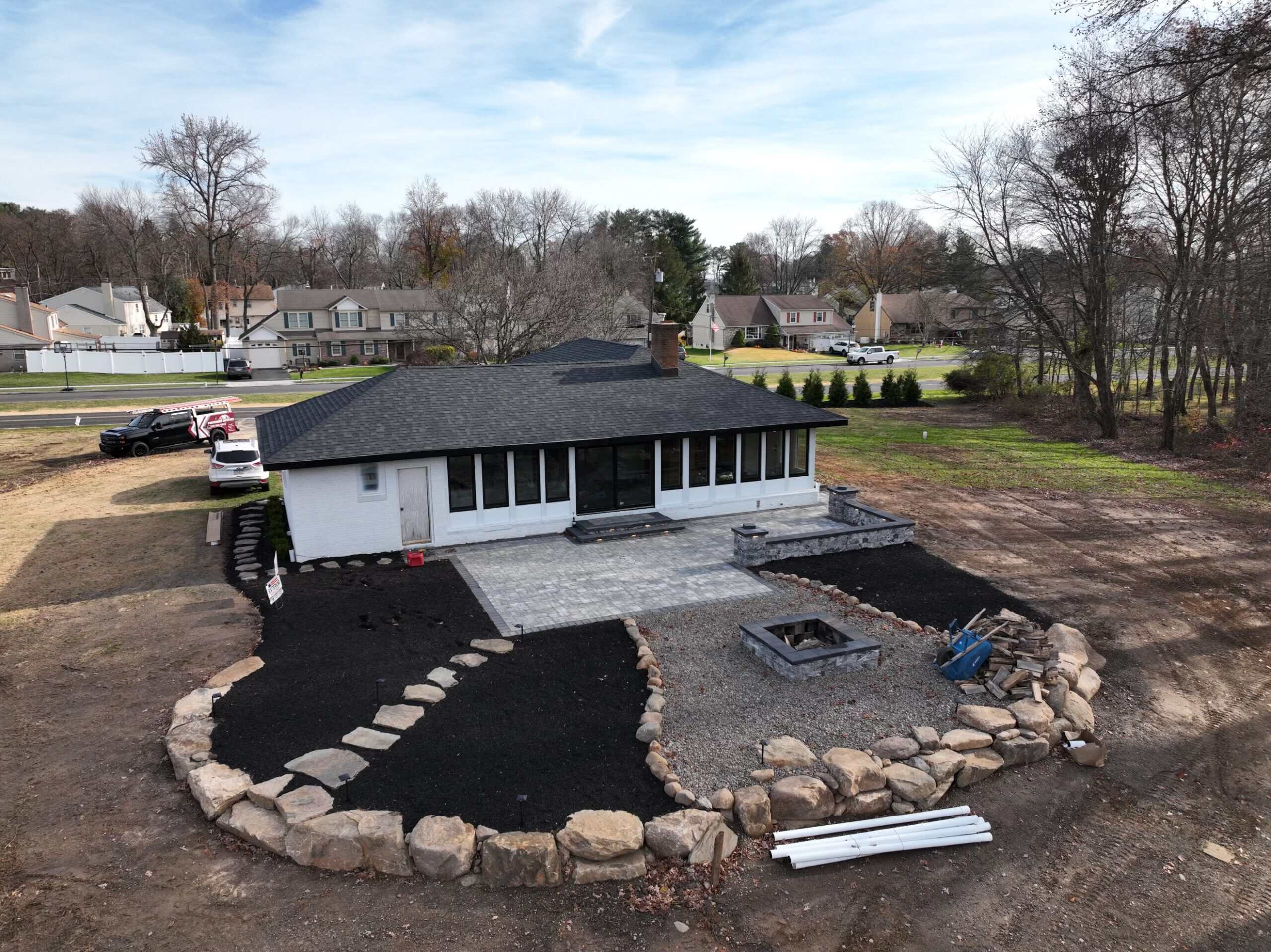 New backyard landscaping with stone border and gravel for C&J Outdoor Services.
