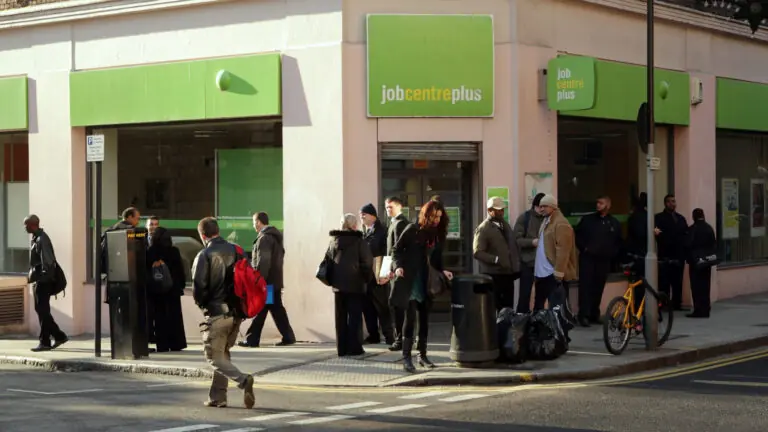 People waiting outside a Job Centre Plus in Britain for employment services.
