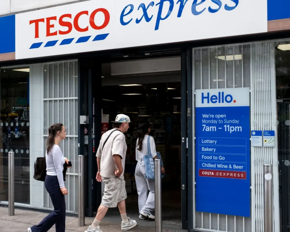 Customers entering Tesco Express convenience store in the UK.