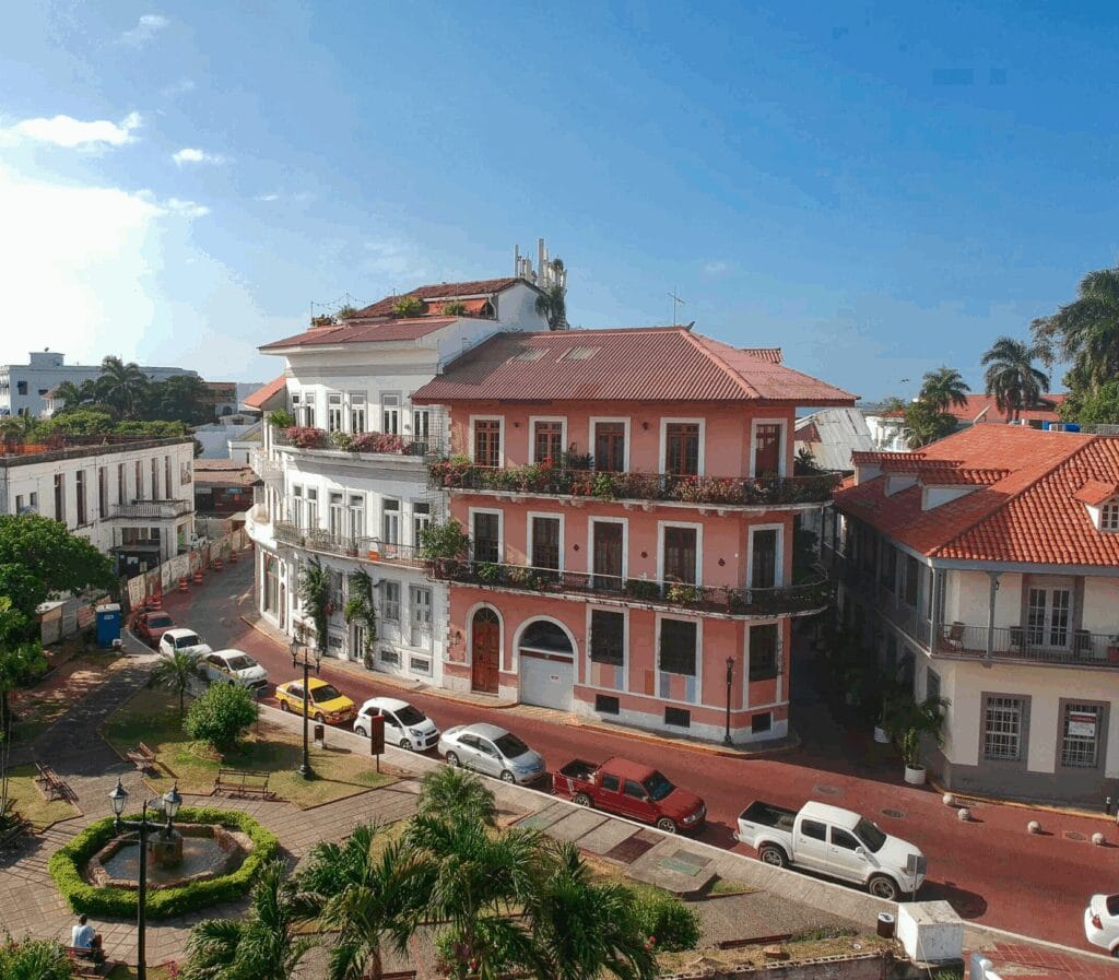 Corner view of Casco Viejo buildings with red rooftops and colonial balconies by Plaza Bolívar