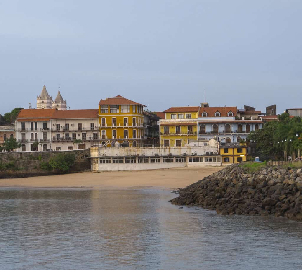 Historic waterfront view of Casco Viejo, Panama, with colorful colonial buildings at sunset