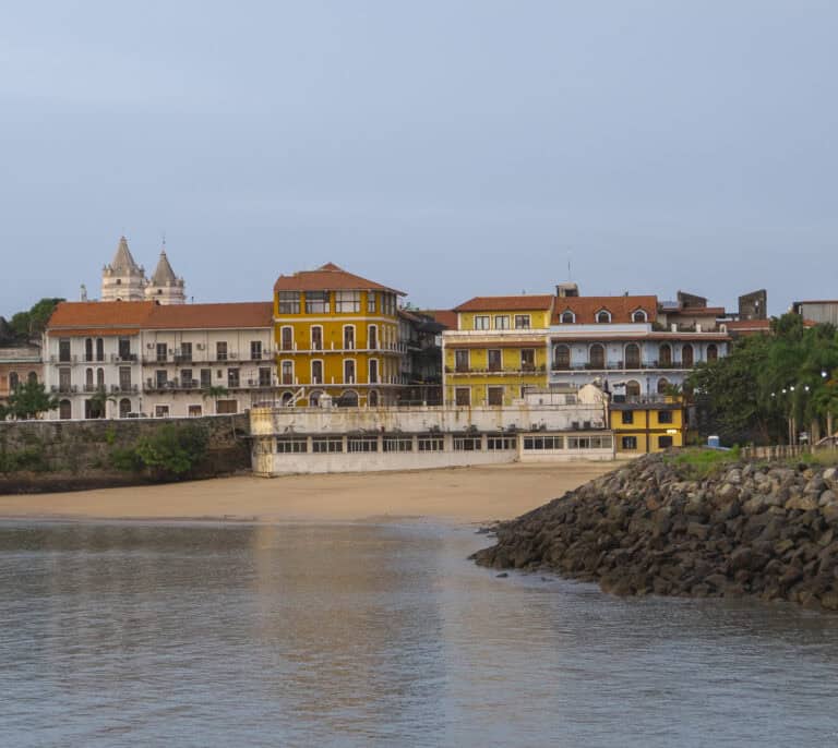 Historic waterfront view of Casco Viejo, Panama, with colorful colonial buildings at sunset