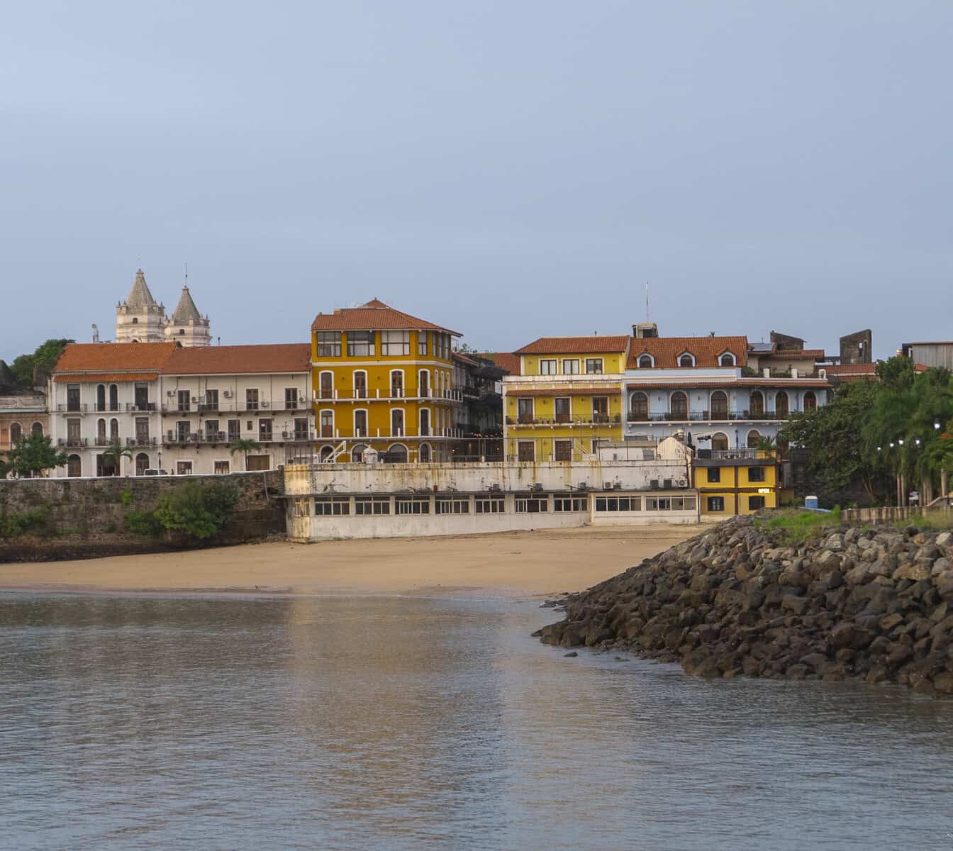 Historic waterfront view of Casco Viejo, Panama, with colorful colonial buildings at sunset