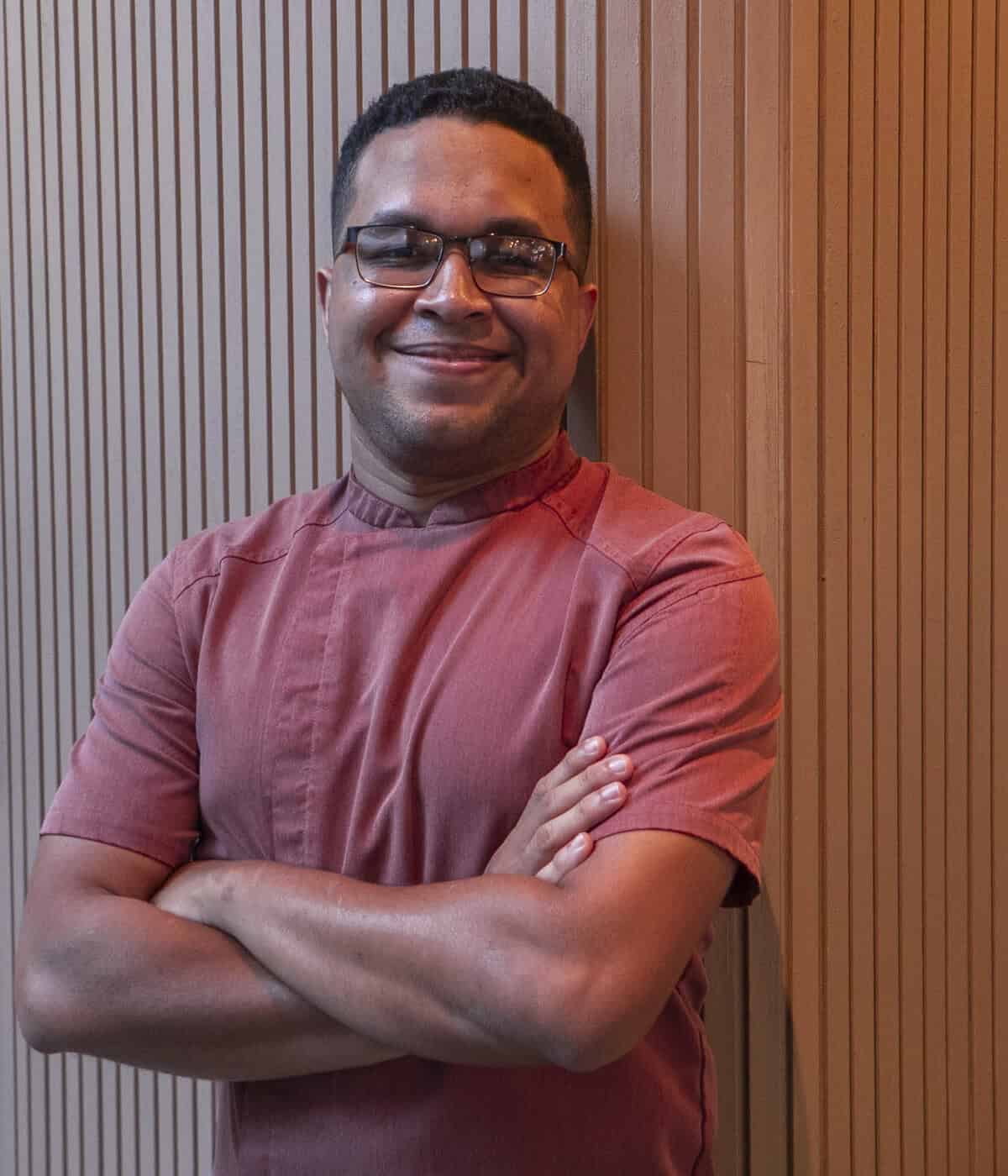 Chef Carlos H. Smith Q. standing confidently in Casco Viejo, Panama City.
