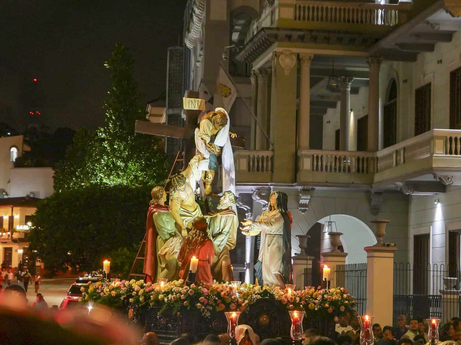 Religious procession during Holy Week in Casco Viejo, Panama, with statues and candles carried through the historic streets at night.