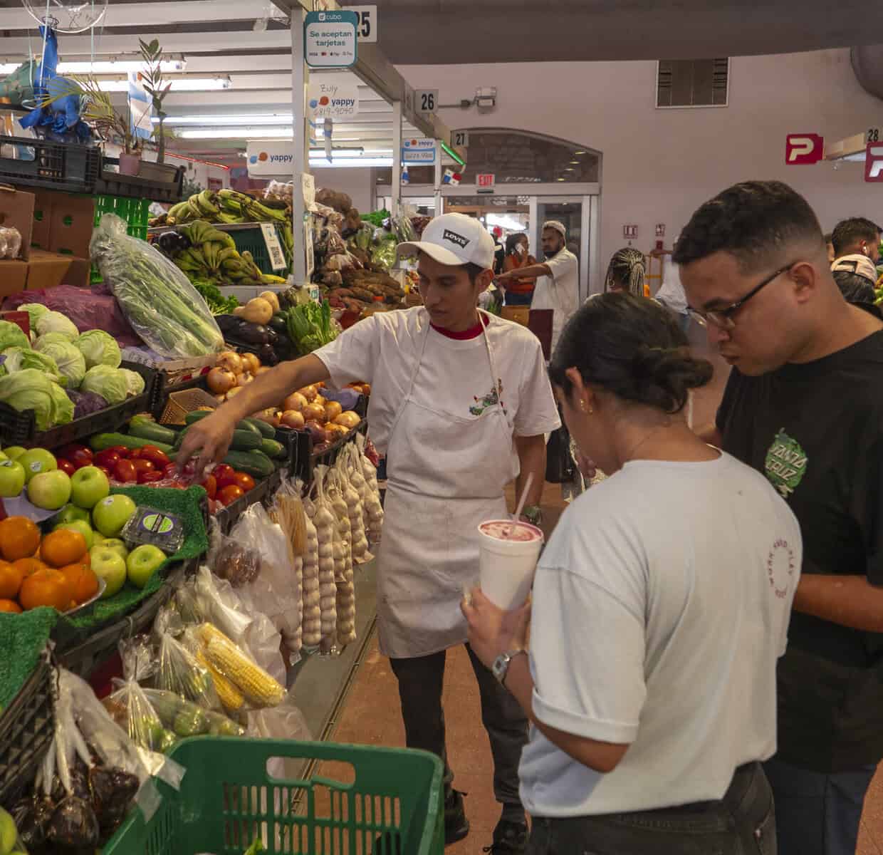 Chefs Ericka Rodriguez and Carlos H. Smith Q. selecting fresh produce at the vegetable market near Casco Viejo, Panama City.