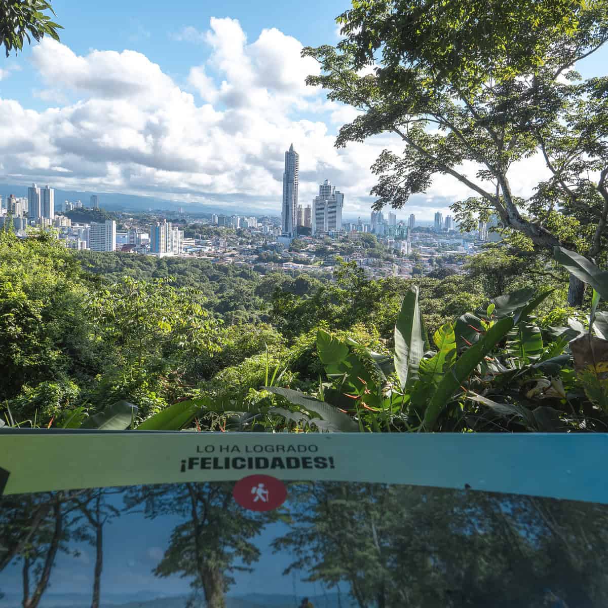 Felicidades sign at the summit of Metropolitan Natural Park overlooking Panama City skyline