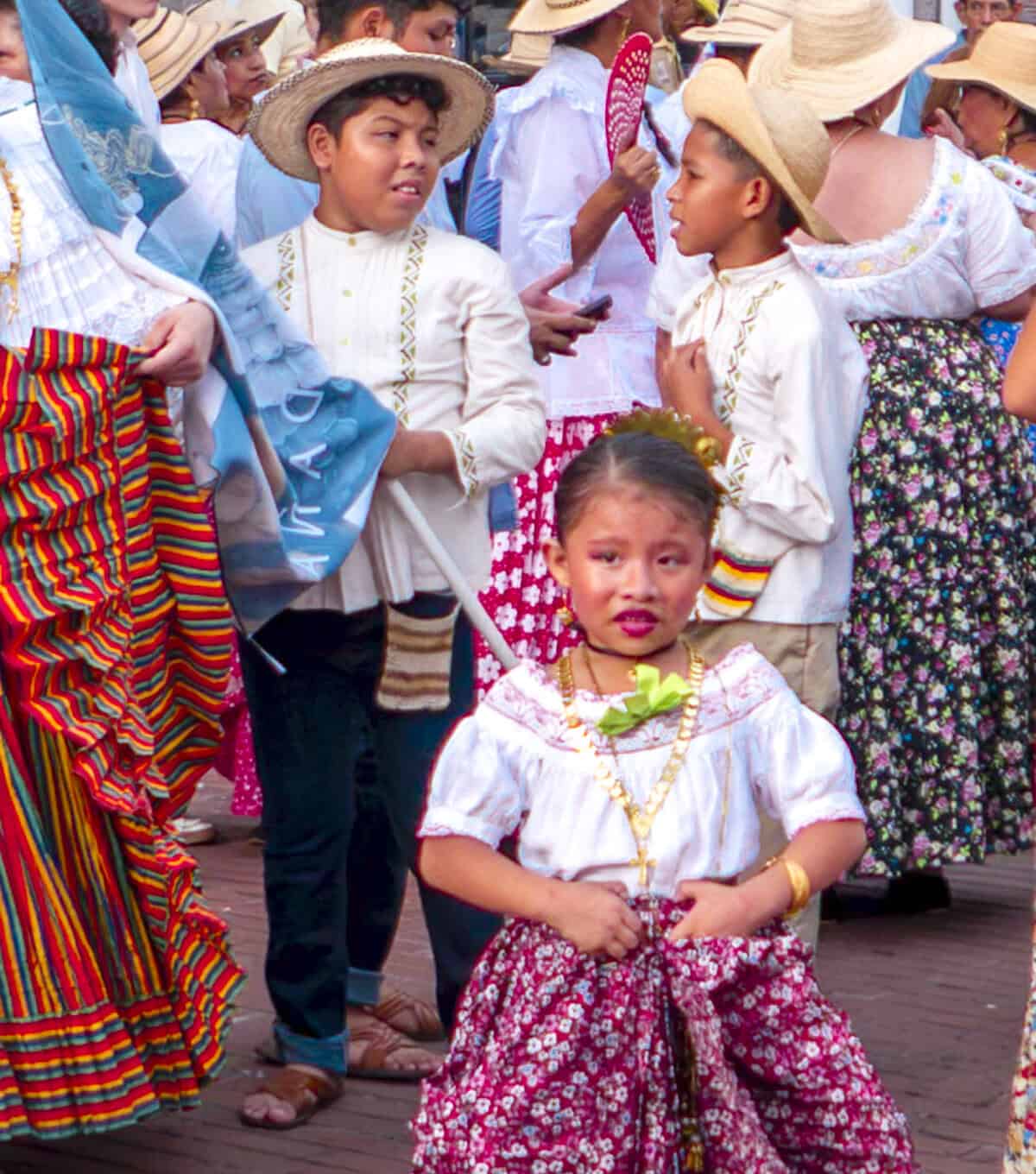 Young Panamanian girl in traditional pollera dress during a cultural parade in Casco Viejo, celebrating Panama’s national holidays and traditions.