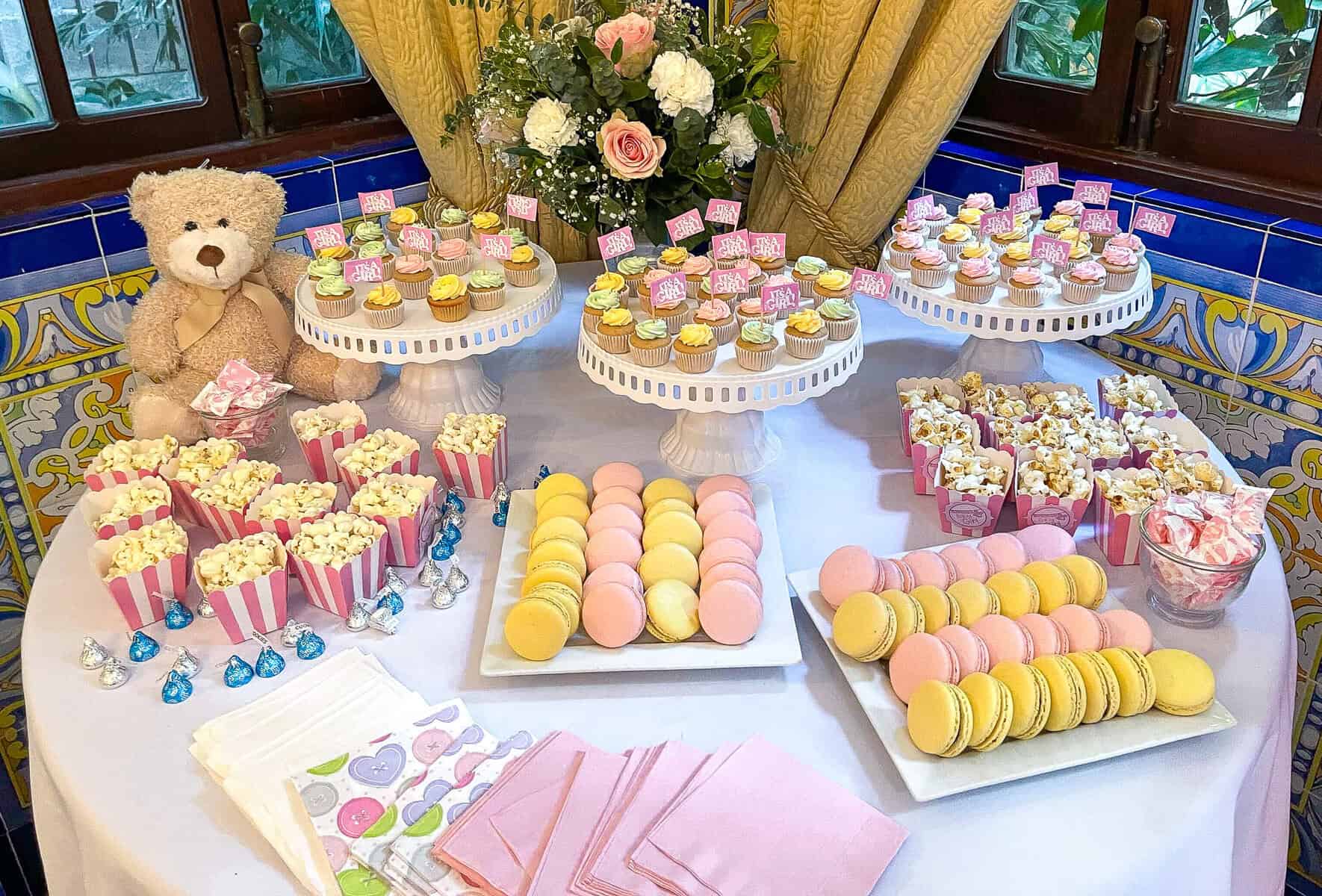 Baby shower dessert table with cupcakes, macarons, popcorn, and candy display at Mahalo in Casco Viejo, Panama