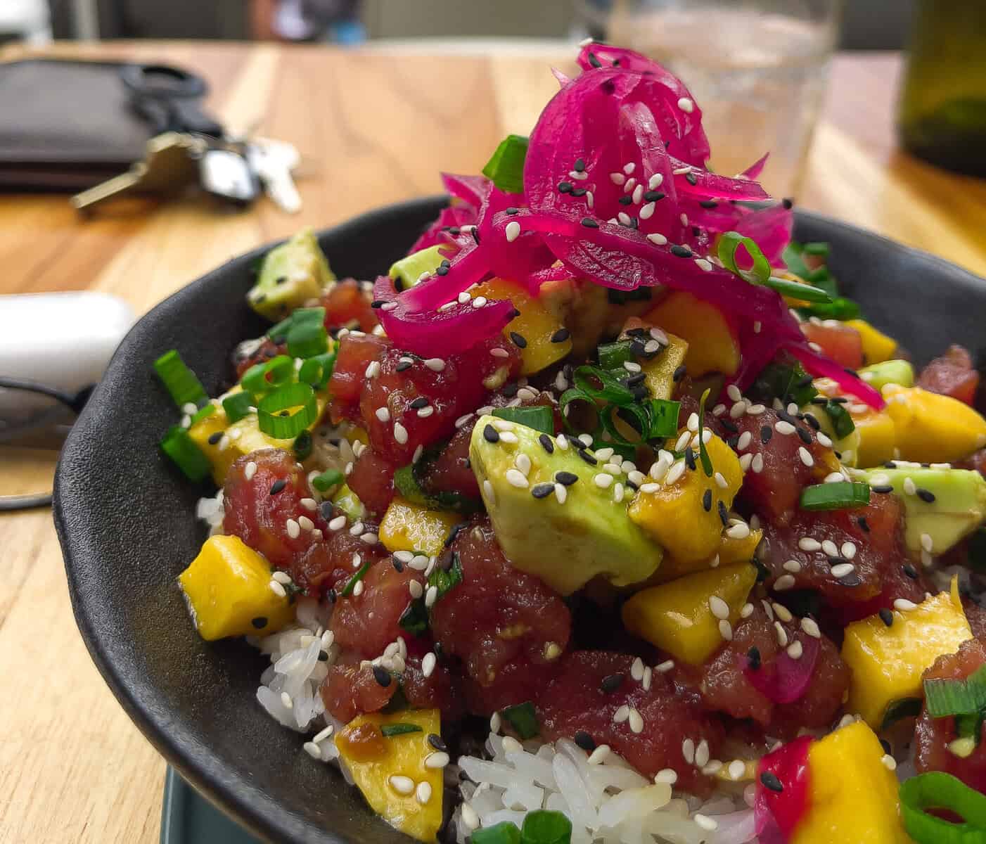 Fresh ahi tuna poke bowl with avocado, mango, sesame seeds, pickled red onion, and rice at Snack Shack in Casco Viejo, Panama