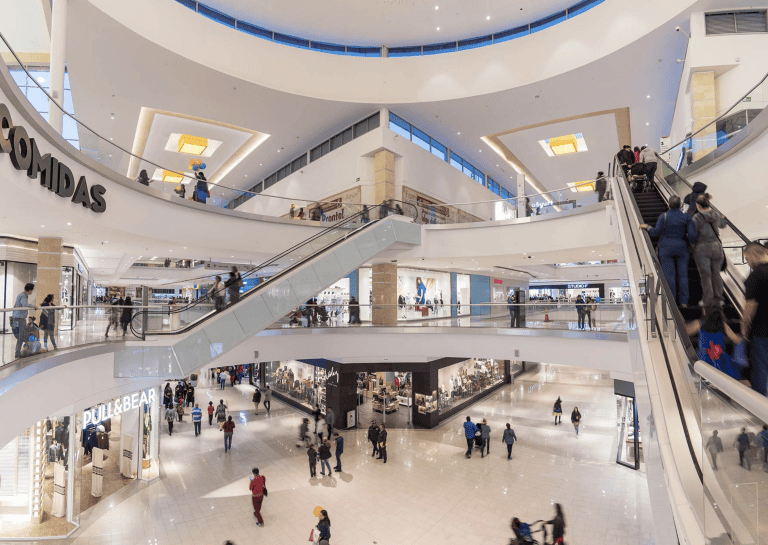 Interior view of Multiplaza Mall in Panama City showing modern shopping levels, escalators, and international retail brands