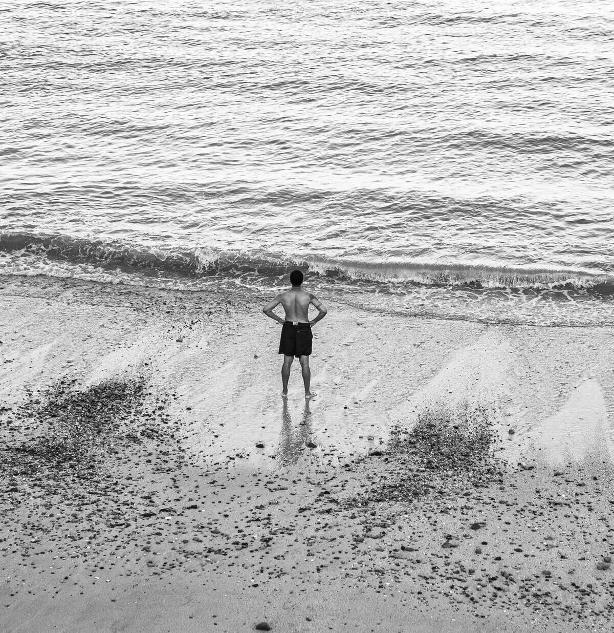 Panamanian man standing at shoreline near Sofitel Legend Casco Viejo