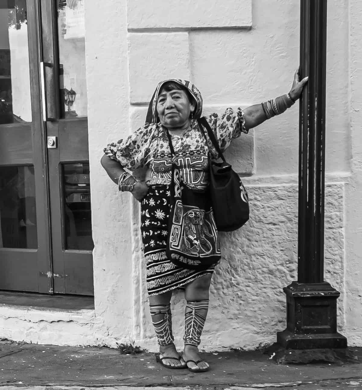 Indigenous woman standing against a colonial wall in Casco Viejo Panama at the start of the day