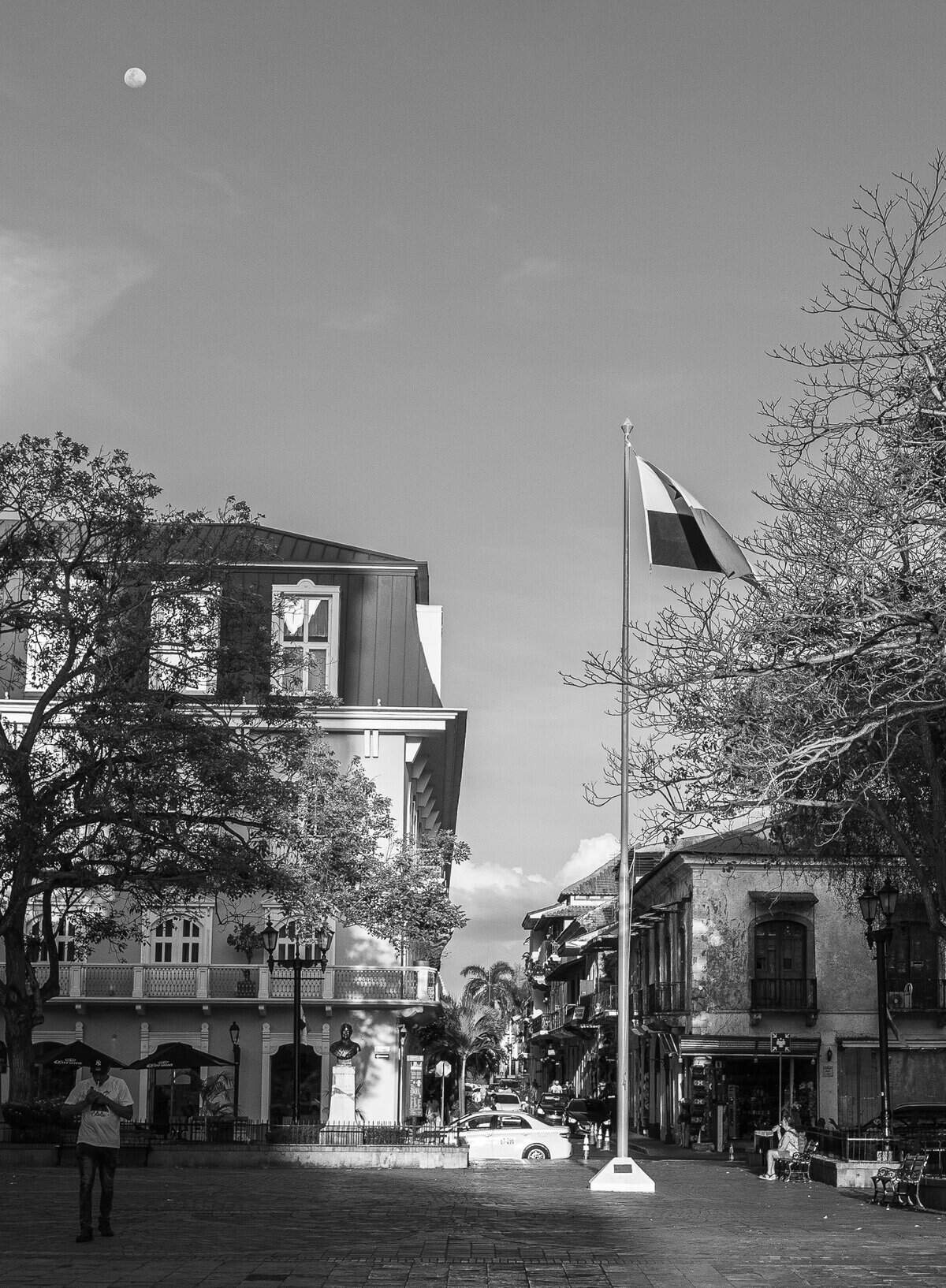 Cathedral Plaza in Casco Viejo Panama photographed in black and white at morning flag raising, with the Central Hotel and surrounding colonial architecture.