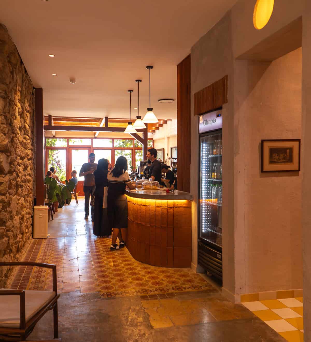 Busy coffee bar scene inside Olympia Coffee Studio Casco Viejo Panama with guests