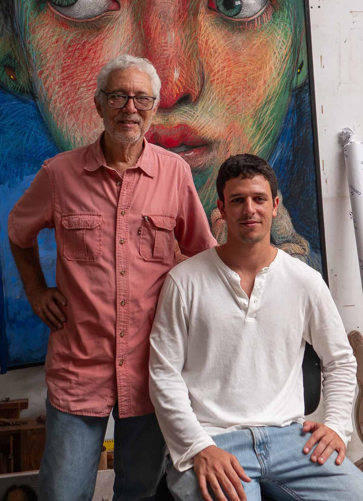 Paulo and his father Brooke Alfaro inside his studio in Casco Viejo Panama with artwork behind them