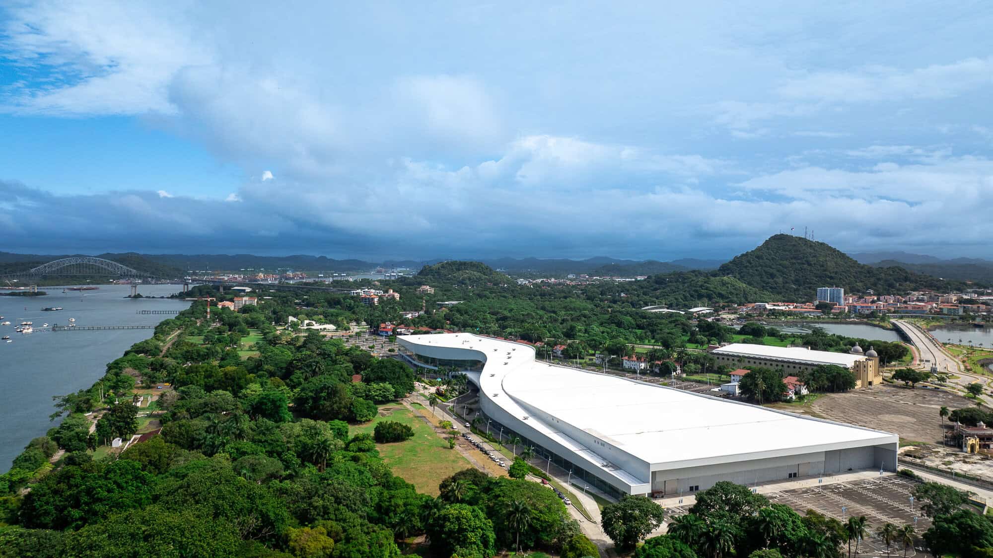 Aerial view of the Panama Convention Center, the Amador Causeway and the Bridge of the Americas along Panama City's Pacific waterfront.