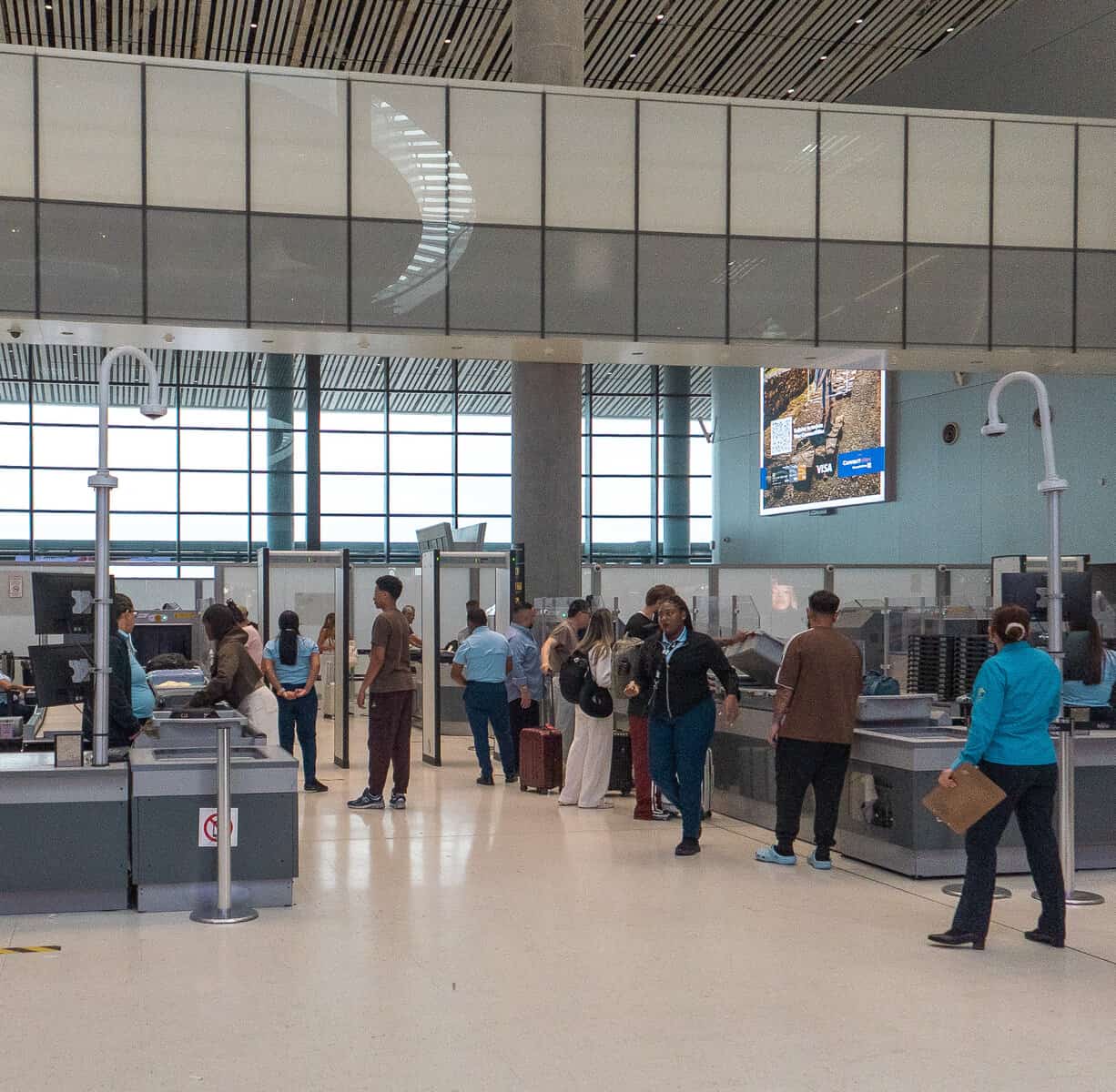 Travelers passing through a security checkpoint at Tocumen International Airport in Panama City.
