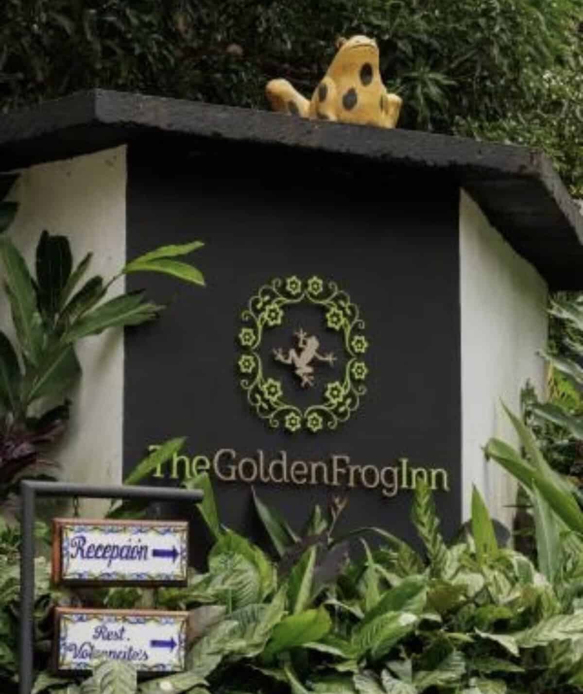 Entrance sign for The Golden Frog Inn surrounded by tropical vegetation in El Valle de Antón, Panama.