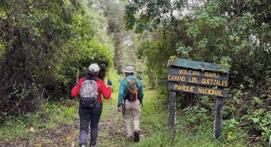 Two hikers entering Los Quetzales Trail in Volcán Barú National Park near Boquete, Panama
